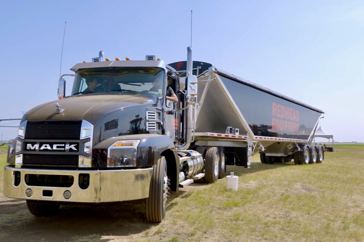 a semi-truck and trailer on the grounds at Ag in Motion