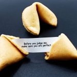 Before you judge me, make sure you are perfect. Cracked chinese fortune cookie with motivational message. Claudio Caridi/iStock/Getty Images