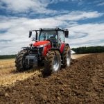 a red massey ferguson tractor operating in the field
