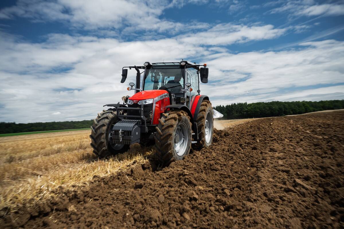 a red massey ferguson tractor operating in the field