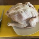 A whole bird on the board, with the boning knife at the ready for cutting. Keep your knife super-sharp for the best result. Pic: dee Hobsbawn-Smith