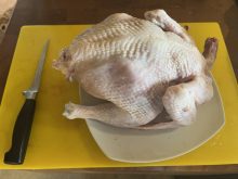 A whole bird on the board, with the boning knife at the ready for cutting. Keep your knife super-sharp for the best result. Pic: dee Hobsbawn-Smith