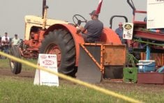 vintage Case tractor in tractor pull with front wheels off ground