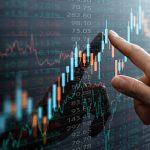 Close up of female hand touching stock market analysis digital display screen TradingView chart, analyzing investment and financial trading data in candlestick chart on a touch screen interface. Business and finance. Investment on NFT and cryptocurrency concept