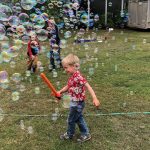 The kids and the puppy had a blast popping the bubbles from the machine that Uncle Mike and Grandma Allen brought for them. Photo: Heather Eppich