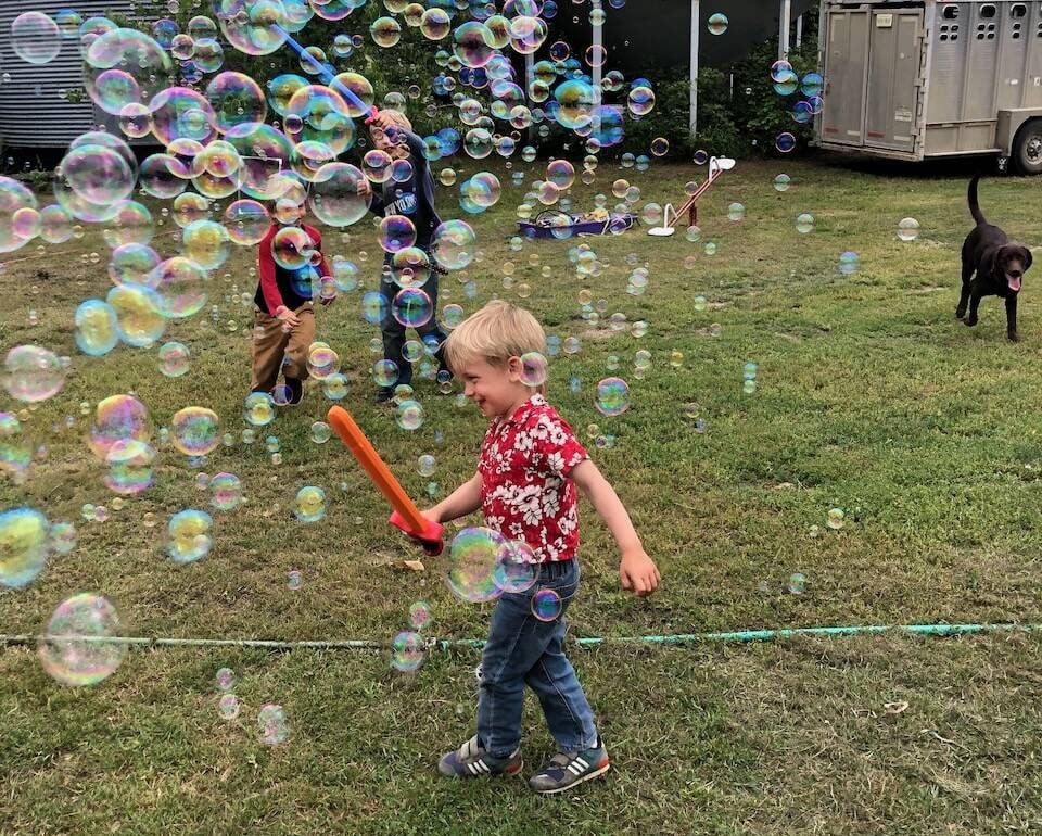 The kids and the puppy had a blast popping the bubbles from the machine that Uncle Mike and Grandma Allen brought for them. Photo: Heather Eppich