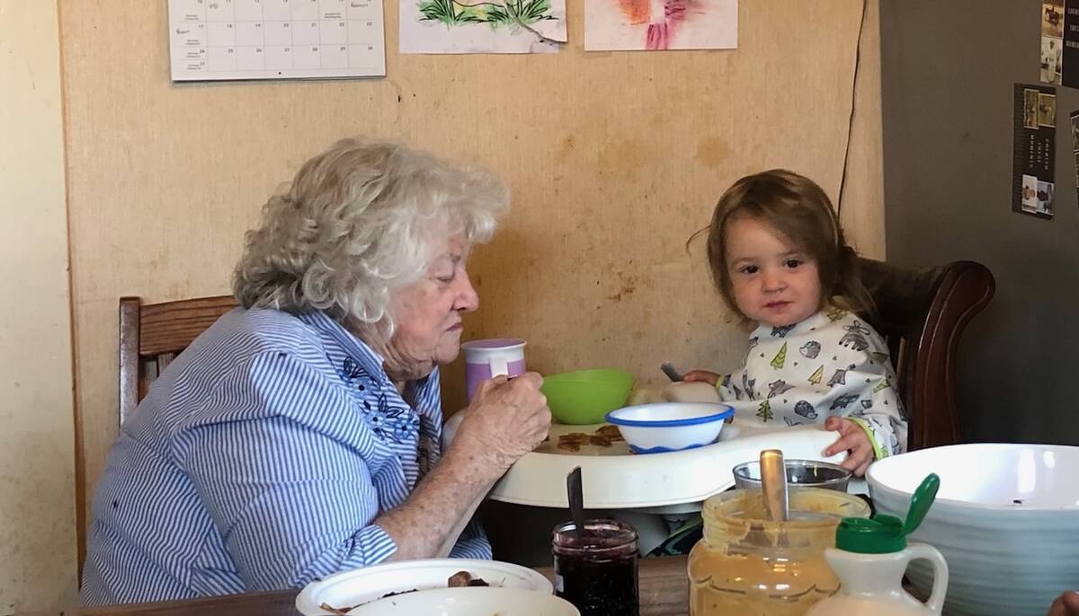 Grandma Allen helps Anna to eat her breakfast and they share stories and giggles. Photo: Heather Eppich