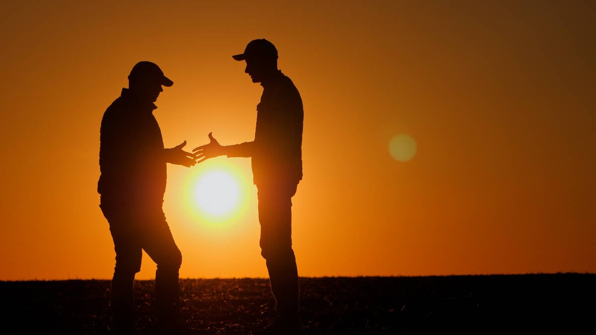 Firm handshake between two farmers in silhouette at sunset. Pic: StockSeller_ukr/iStock/Getty Images
