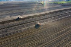 Aerial drone view of tractor working on agriculture spring field. photo:erika8213/stockimages