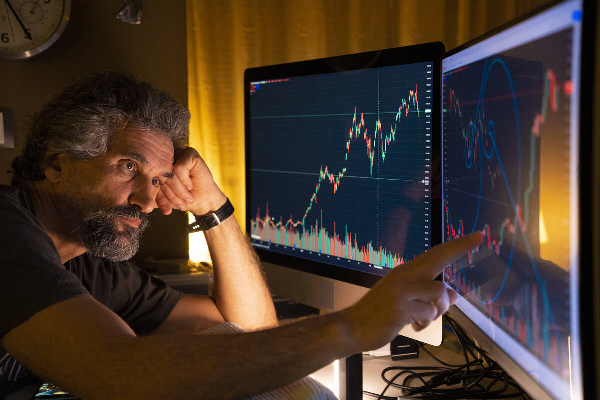Business people making new business strategies and checking on stock markets trading positions. Close up of hands in front of digital displays with multidata on Trading View. Daniel Balakov/E+/Getty Images