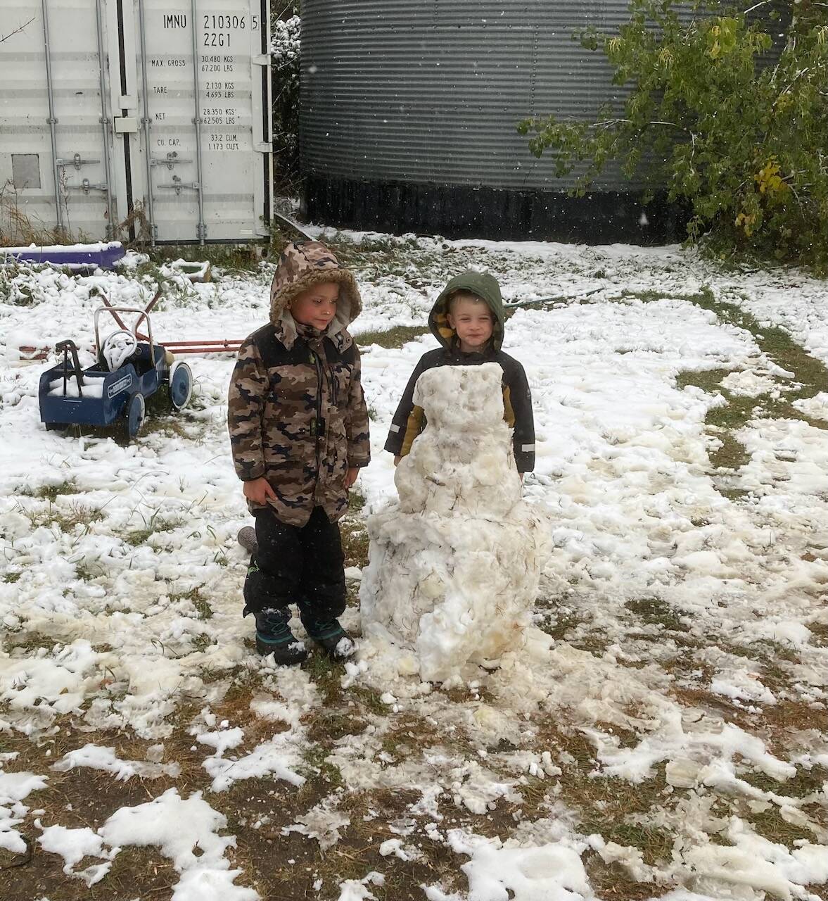 James and Ian are proud of their first snowman of the year.