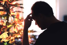 Sad on Christmas. Unhappy, lonely or tired man with stress, grief or depression. Family fight, loneliness, frustration or money problem on Xmas. Sick person with flu, pain and headache on holiday. Tero Vesalainen/iStock/Getty Images