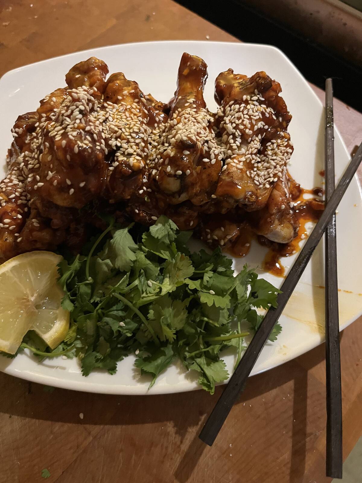 Serve wings garnished with extra sauce, sesame seeds, and minced green onions or cilantro.