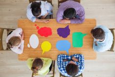 Team of business people in casual clothes sitting around the table with paper dialog boxes, discussing opinion concept. Photo: ALotOfPeople/iStock/Getty Images
