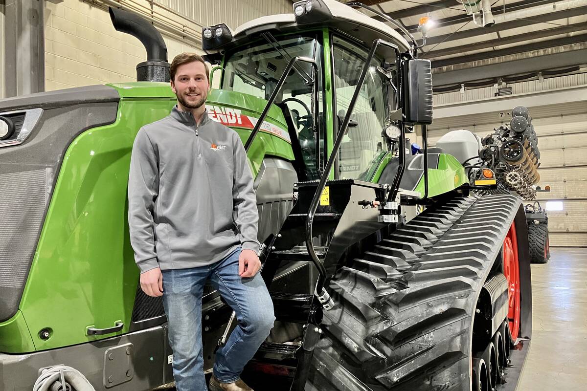 Eric Bossuyt, an account manager with AgWest in Russell, Man., on the steps of a Fendt Vario tractor connected to a Fendt Momentum planter at the dealership in Elie.  Photo: Greg Berg