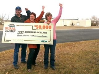 It only takes 5 million pennies to make some people happy. Above Hussar community volunteers from left, Peter Sanden, Kathy Dundas and Wendy Kaiser with UFA cheque.