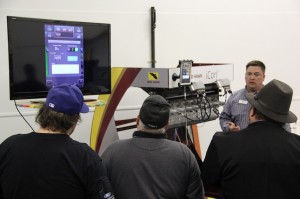 Kurt Raffey uses a classroom simulator to demonstrate how to input instructions