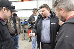 Chirs Morson shows farmers the metal shot used to blast all production steel to remove mill scale, reducing the risk of impurities contaminating welds and improving paint adhesion