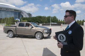 Guinness World Records adjudicator, Michael Empric, counts Ram trucks as they return from breaking a record for the largest parade of pickup trucks Saturday, April 18, 2015.