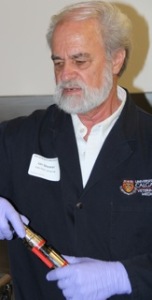 Dr. Jan Shearer demonstrates proper cleaning of a captive bolt gun.