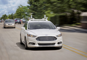 A Ford Fusion Hybrid guides itself down the street.
