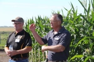 Rodger Hovde, left and Talbot Bergsma, corn specialist with Dow AgroSciences talk about corn production.